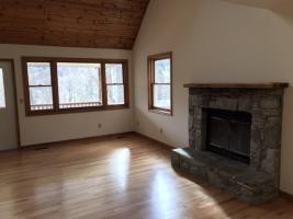 View of Living Room to Wood Fireplace